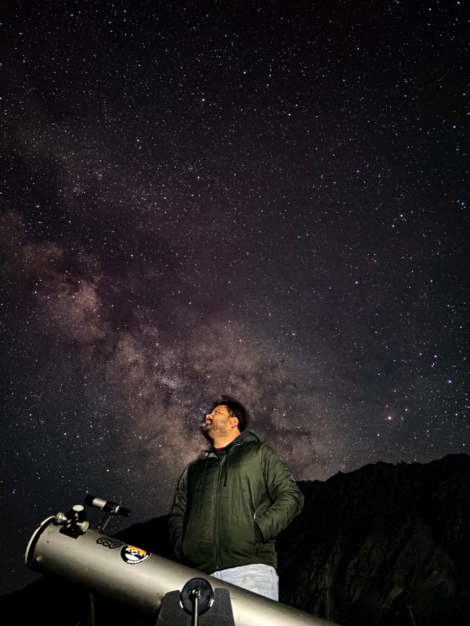 Stellar Adventures guide beside a Newtonian telescope under the Milky Way in Ladakh